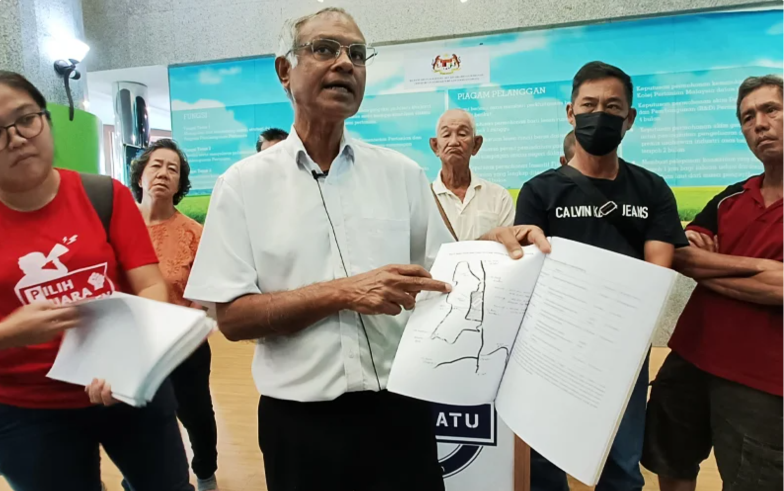 Dr Jeyakumar standing with memorandum.